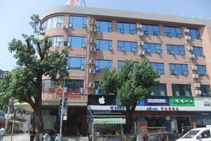A multi-story building with commercial establishments on the ground floor, including a Samsung and an Oppo store.