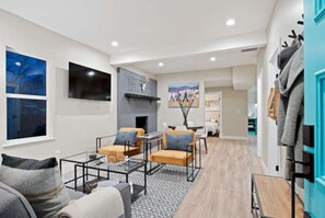 A modern living room with a fireplace, seating area, and artwork on the walls. - SuperChic Farmhouse*Old Town Arvada*LightRail*Dogs (Arvada)