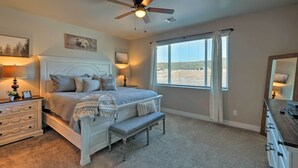 A bedroom with a bed, bedside tables, a ceiling fan, a window with curtains, and a dresser. - Flagstaff Home w/ Views - Near Arizona Snowbowl! (Flagstaff)