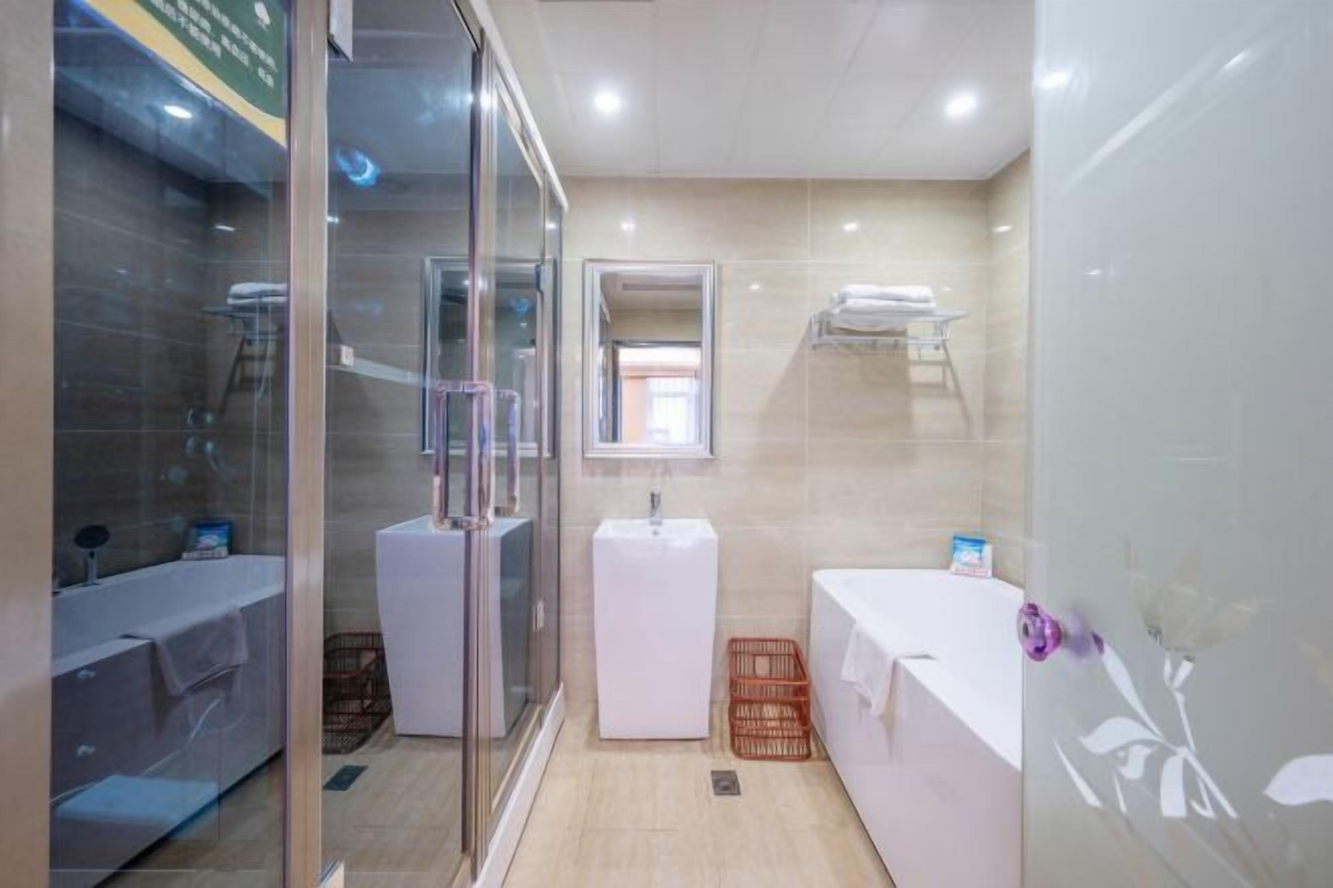 A modern bathroom with a glass shower enclosure, a white sink, and a bathtub.