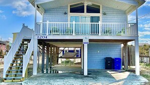A two-story beach house with a balcony, a covered porch, and a number 1204 sign. - Pets OK Beach Home+Short Walk Beach Access+Views! Recent Updates & Upgrades (Surf City)