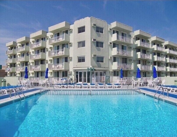 Guests can enjoy a resort-like atmosphere with a central pool and outdoor space on each floor.