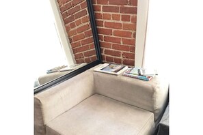 Relax in a cozy corner with a cushioned bench and a window view.