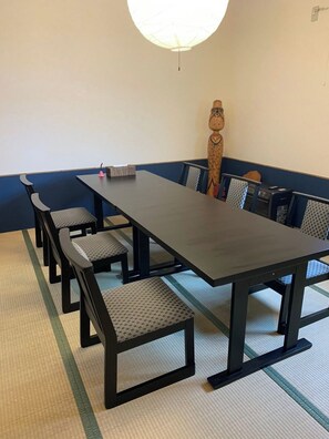 Meetings take place around a long table in this conference room, surrounded by six chairs.