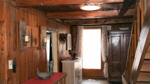 A wooden interior with a bench, a door, and a light fixture. - Lamplberg by Interhome (Hippach)