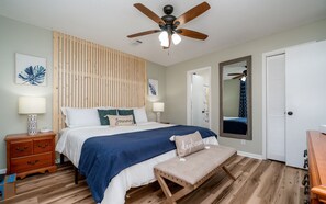 Cozy retreat with a large bed, bedside tables, and a wooden bench.