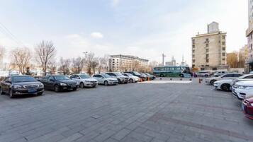 A parking lot with multiple cars and a bus.