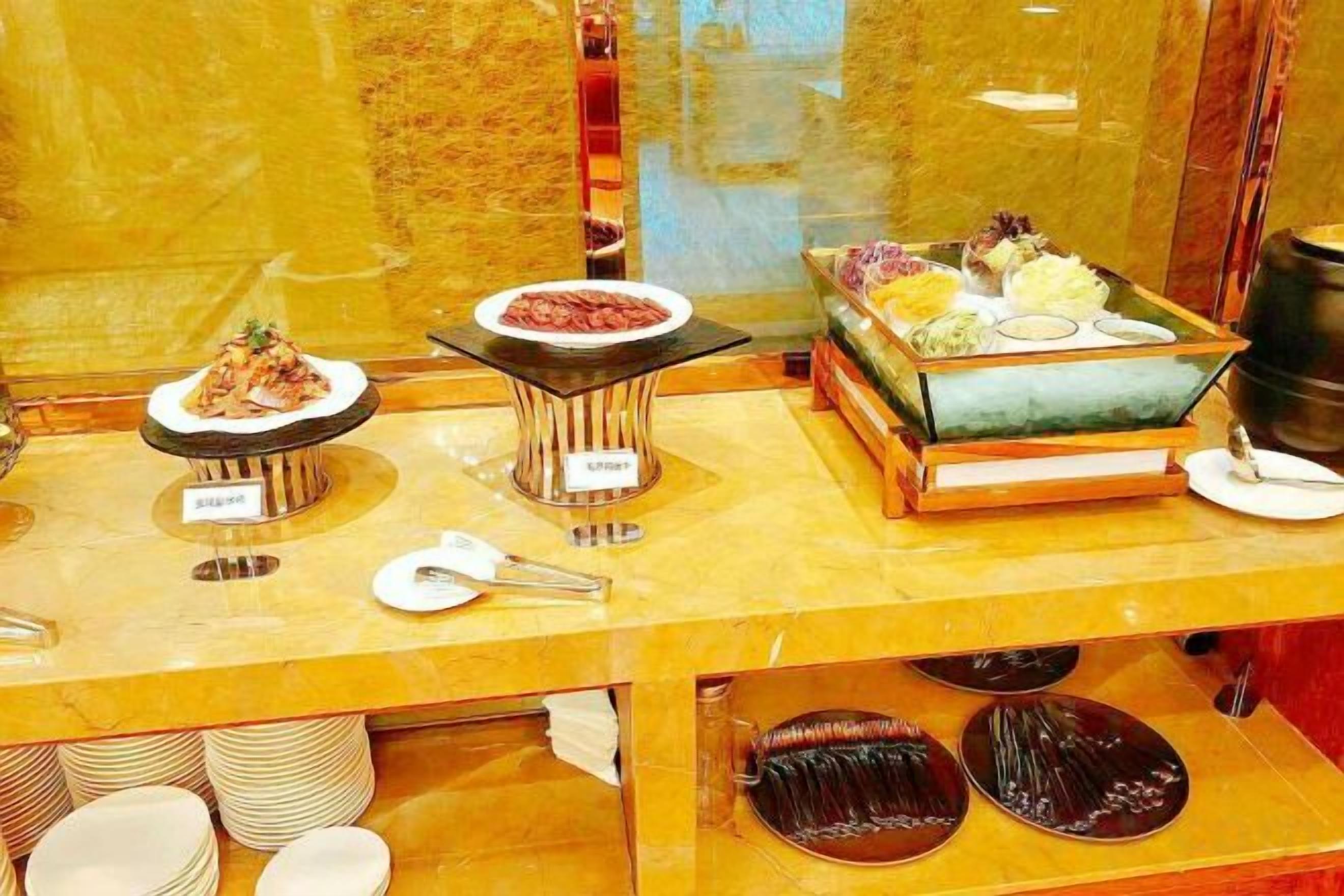 A buffet with various dishes and utensils.