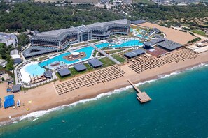 A resort with a large pool, beach area, and a pier. - Lago Hotel Ex Azura Deluxe Resort and Aqua Sorgun (Manavgat)