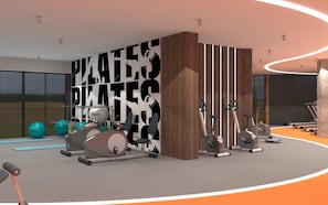 A modern gym with exercise equipment, a large wall with text, and a view of the outdoors. - Lago Hotel Ex Azura Deluxe Resort and Aqua Sorgun (Manavgat)
