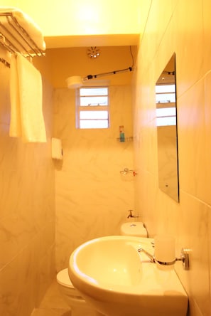 A bathroom with a sink, toilet, and a small window. - Stay.Plus Ebony Mara House (Narok)