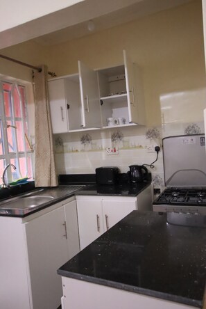 Business House | Private kitchen | Fridge, microwave, cookware/dishes/utensils, dining tables - Stay.Plus Ebony Mara House (Narok)