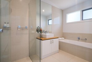 A modern bathroom with a glass shower enclosure, a white sink with a wooden countertop, and a large bathtub. - The Salt House - Poolside amongst the Moonah Trees (Rye)