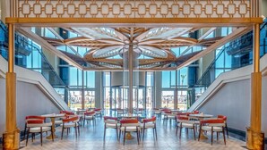 A spacious indoor area with multiple seating arrangements and a central decorative ceiling structure. - Lago Hotel (Manavgat)