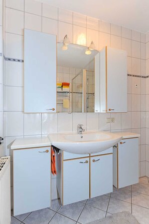 Een haardroger, handdoeken, zeep, toiletpapier