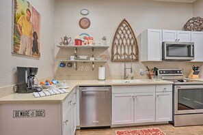 Enjoy cooking in this well-equipped kitchen with a gas stove, microwave, and ample storage.