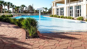 A swimming pool with a white gazebo, surrounded by a brick walkway and palm trees. - Ariel Dunes I 1407 *Beach Access*3 pools* (Miramar Beach)
