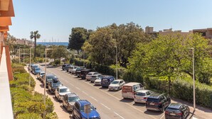 A parking lot with multiple cars and a van, surrounded by greenery and buildings. - L'Amirauté by Interhome (Bormes-les-Mimosas)