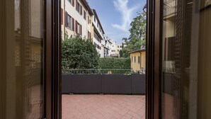A view from a balcony with a tiled floor, a metal railing, and buildings in the background. - Duomo Luxury House by Mmega (Florence)