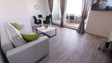 Deluxe Apartment, 1 Bedroom, Non Smoking, Pool Access | Living area | 45-inch flat-screen TV with satellite channels, TV