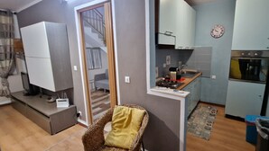 A compact living space with a kitchenette, a dining area, and a staircase leading to an upper floor. - View of the gulf of castellammare mountains and beach (Alcamo Marina)