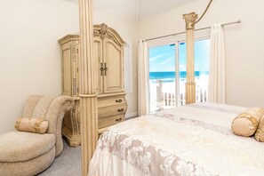 A bedroom with a bed, a wardrobe, and a view of the ocean. - @ The Beach - 7BR Oceanfront Home in Hampton Colony (North Topsail Beach)