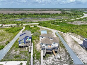 A coastal property with two main buildings, a dock, and a road leading to a bridge. - @ THE PEACH offers an escape to an oceanfront/oceanside (Sneads Ferry)