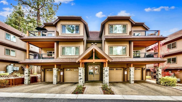 A multi-story residential building with a symmetrical facade, multiple balconies, and a central entrance with a decorative archway. - Prime Walk-to-Heavenly Townhome w/ A/C | TW702 (South Lake Tahoe)