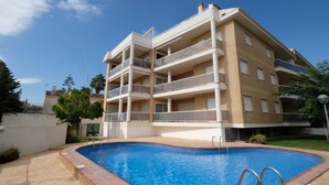 A multi-story building with a swimming pool in front. - Residencial Mar I by Interhome (Alcanar)