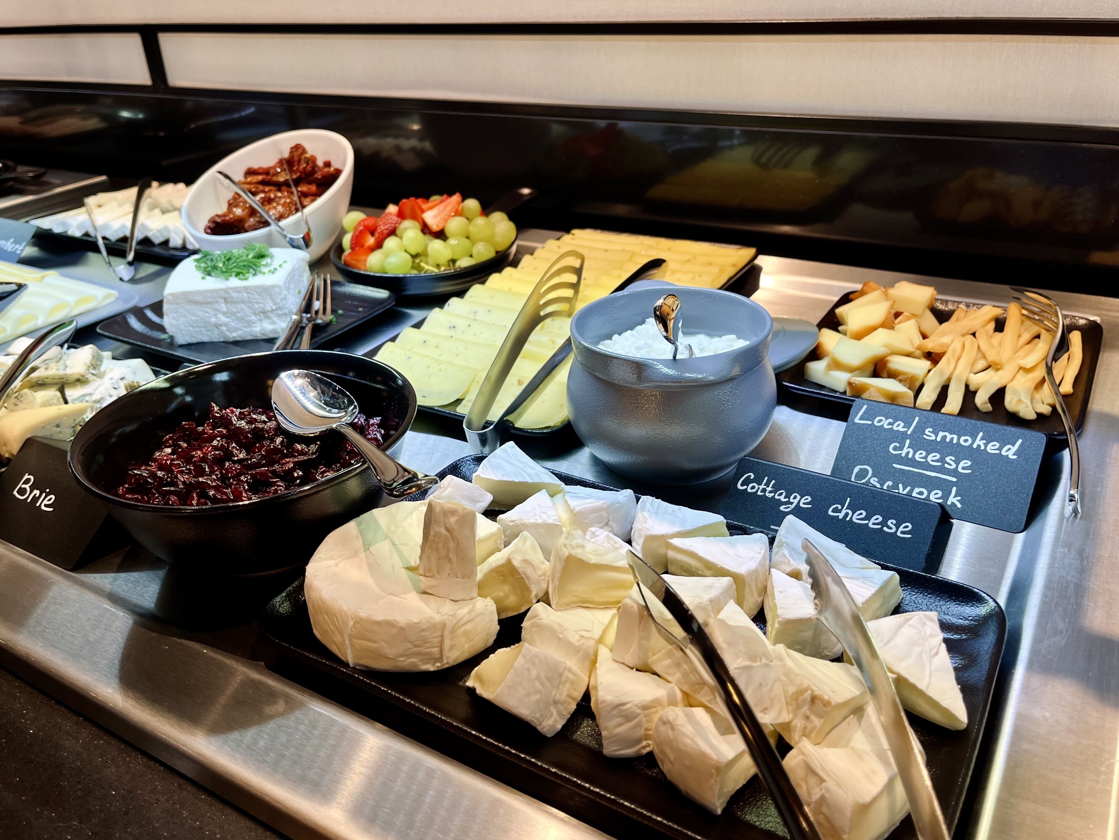 A cheese and fruit buffet with labels for 'Brie' and 'Cottage cheese'.