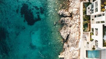 Enjoy breathtaking views of the turquoise sea from the property's multiple balconies and terraces.