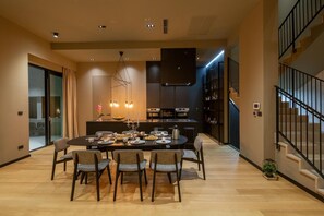 Enjoy meals with friends and family at this spacious dining area, featuring a round table and six comfortable chairs.