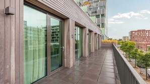A modern building with large windows and a balcony. - Bens The Highdocks (Amsterdam)