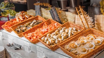A seafood buffet with various types of shellfish and seafood displayed in wicker baskets.