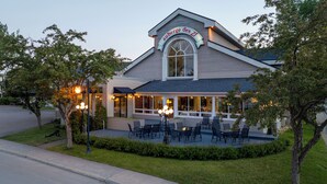 A restaurant with outdoor seating and a covered patio area.