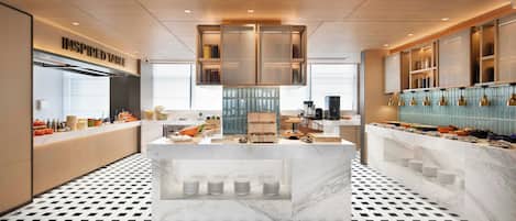 A modern kitchen with a central island, built-in storage, and a patterned floor.