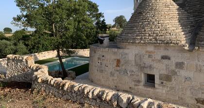 Aprus trullo surrounded by greenery with private pool.