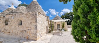 Aprus trullo surrounded by greenery with private pool.