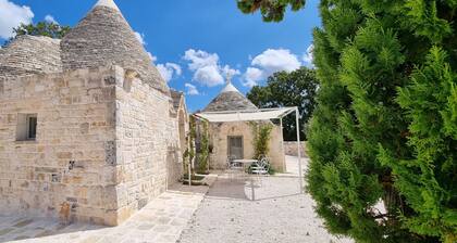 Aprus trullo surrounded by greenery with private pool.