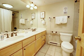 A bathroom with a double sink, a toilet, a shower, and a vanity with drawers. - New Listing! Ski in/out Center Village Hotel Room Lots of bedding CM217 (Copper Mountain)