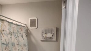A bathroom with a shower curtain, toilet, and a vent on the wall. - lovely relaxing room with hight speed internet , neflix with a independent entry (Goose Creek)