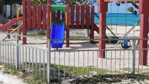 Ein Spielplatz mit Rutsche, Schaukeln und einer Kletterkonstruktion.