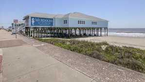 Un bâtiment situé en bord de mer, appelé « MURDOCHS », avec une enseigne publicitaire pour la bière, les cadeaux, les coquillages et les t-shirts. C’est une entreprise familiale qui existe depuis 1910.