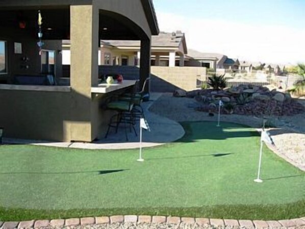 A golf course with a covered area and a patio.