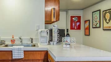 Fridge, microwave, coffee/tea maker, cookware/dishes/utensils