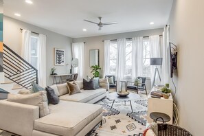 Relax in this inviting living room with a sofa set, coffee table, and floor lamp.