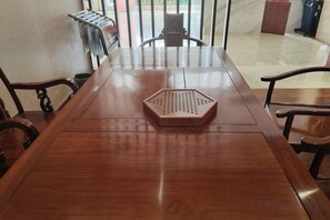 A wooden conference table with a hexagonal object in the center, surrounded by chairs.