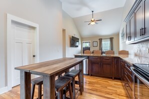 Enjoy cooking in this well-equipped kitchen with a central island, sink, and dishwasher.