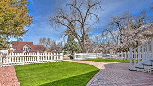 A well-maintained lawn, white picket fence, and a brick pathway leading to a house with a red roof. - 2 blocks to Downtown Square ! (Prescott)
