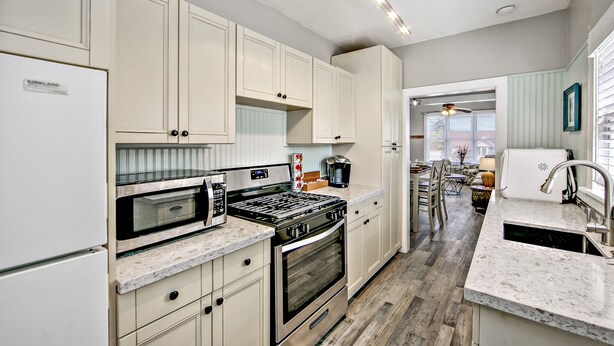 A modern kitchen with white cabinets, stainless steel appliances, and a marble countertop. - 2 blocks to Downtown Square ! (Prescott)